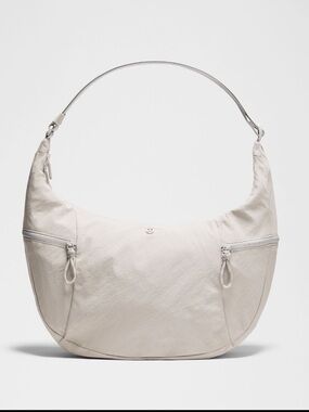 Lululemon Large Slouchy Sling Bag 13L light ivory with silver-NWT